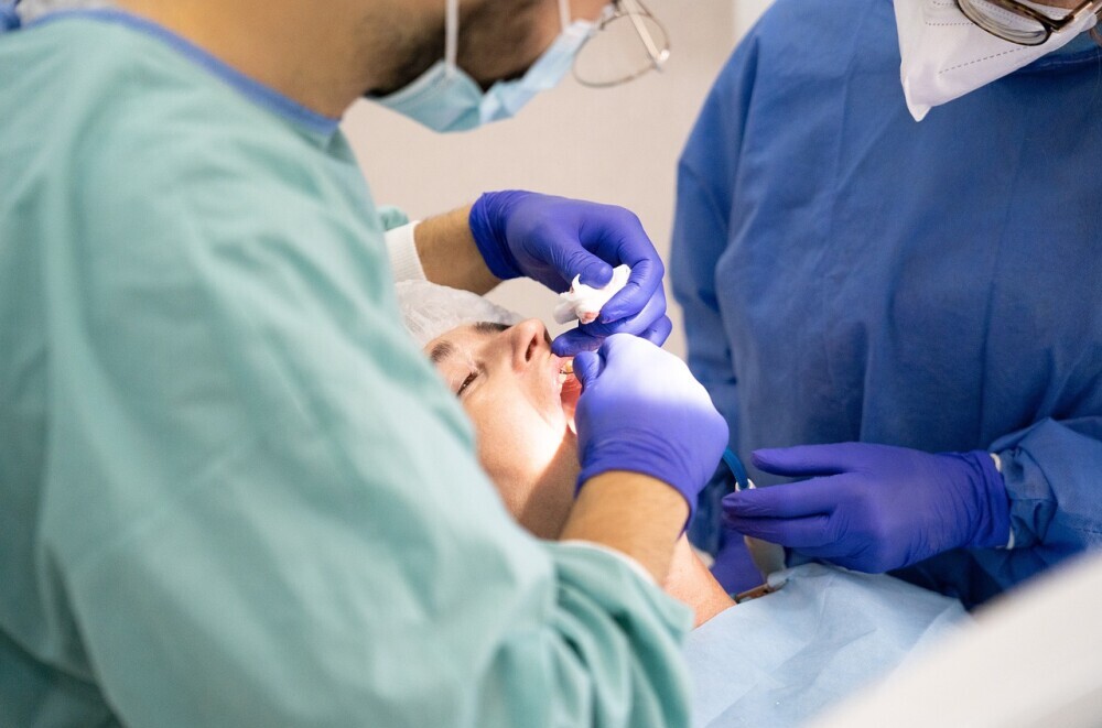 Someone getting his or her teeth cleaned by a professional